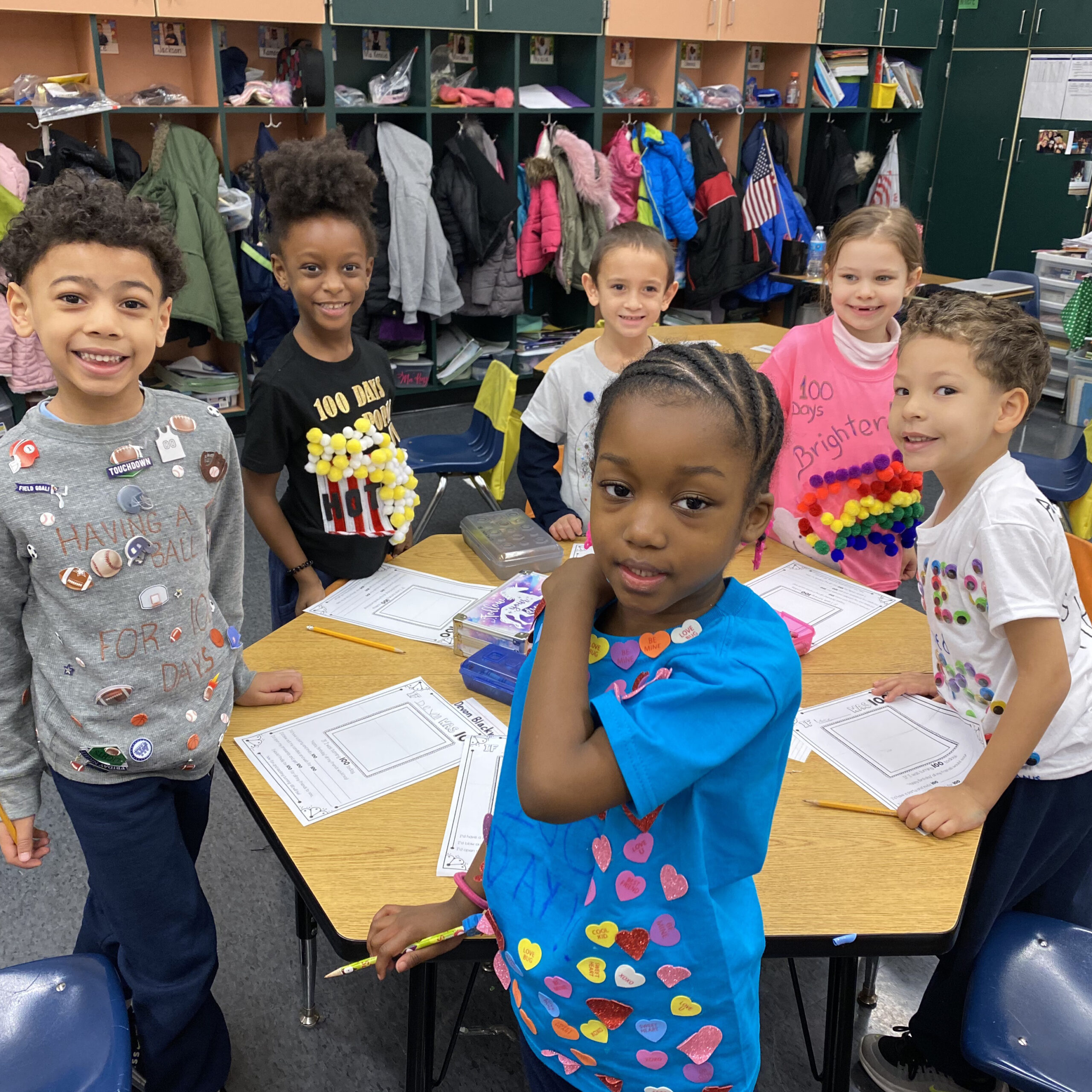 Group of students wearing creative shirts for the 100th Day of School celebration